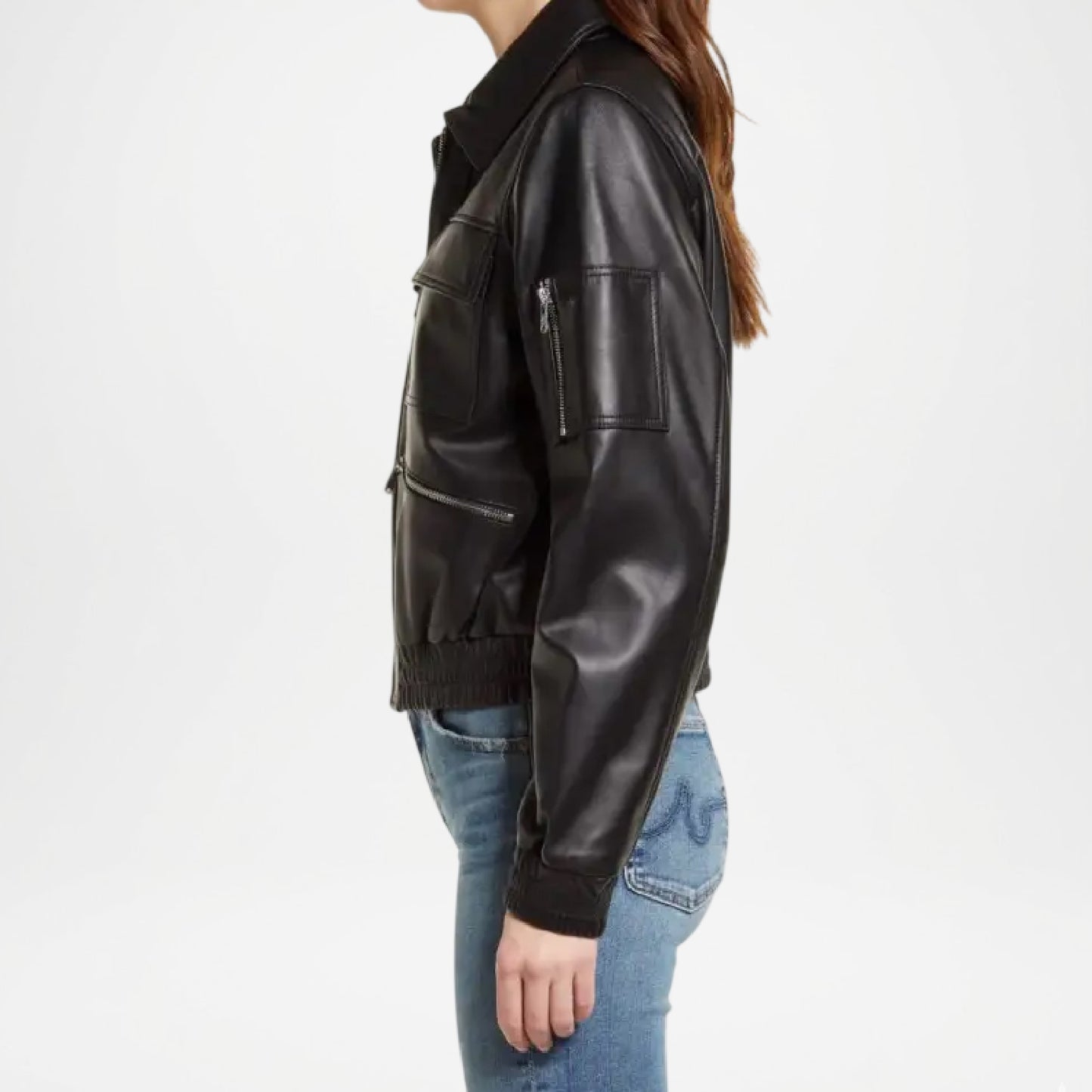 Person wearing a black leather jacket and blue jeans on a white background