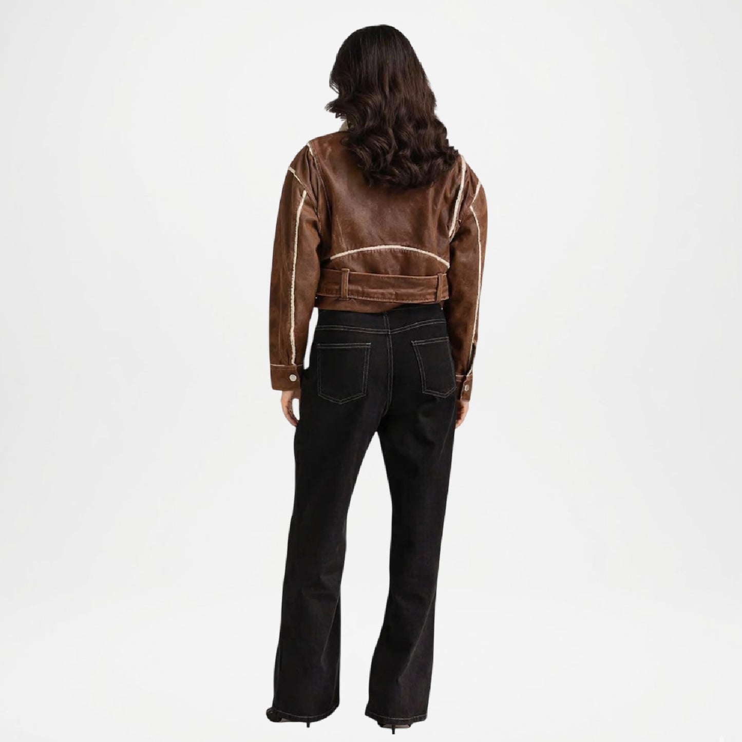 Person wearing a brown jacket and black pants back view