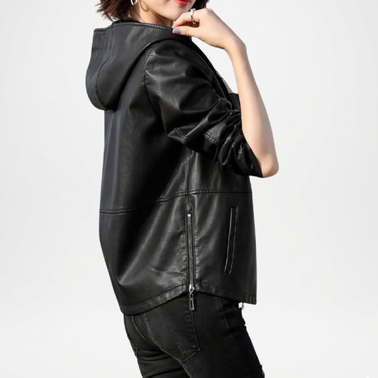 Black leather jacket worn by a person on a light gray background
