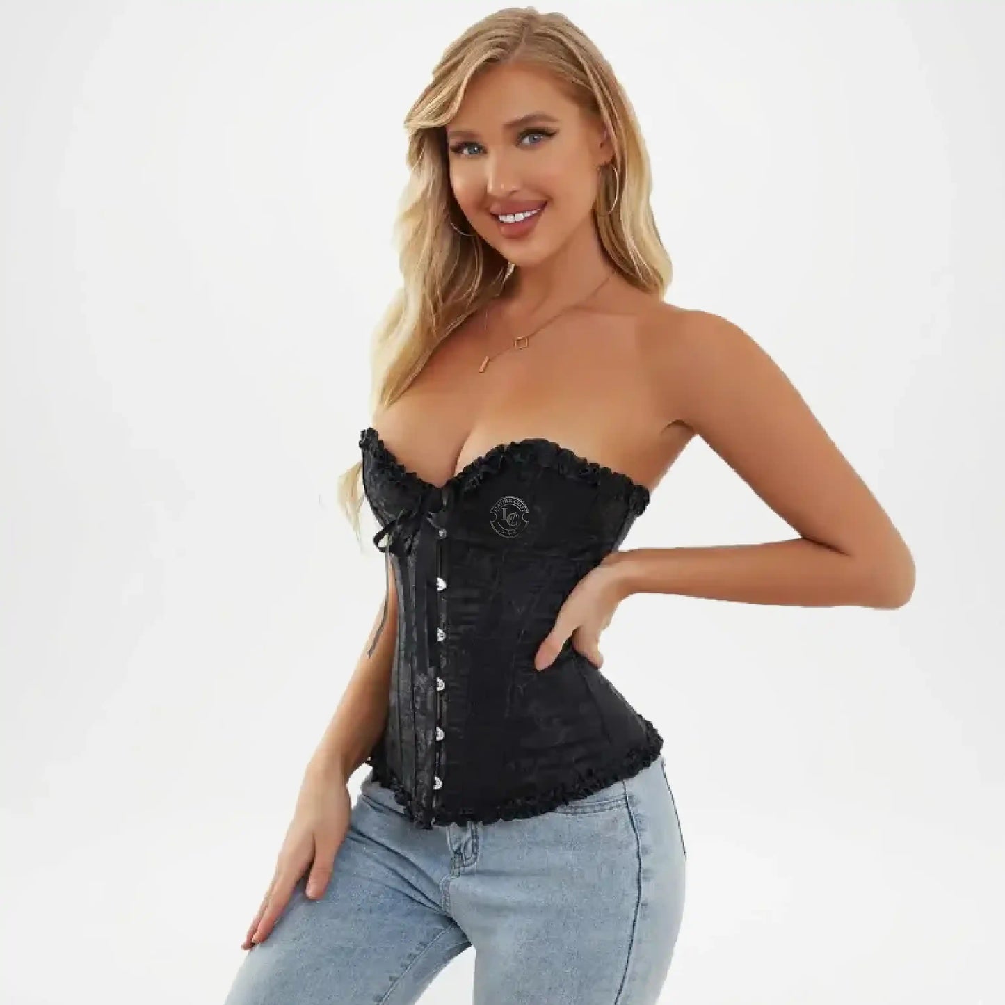 Woman wearing a black corset and light blue jeans on a white background