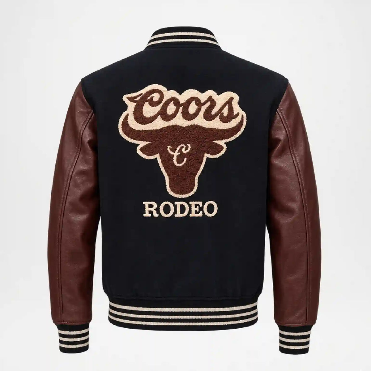 Back view of a varsity-style leather jacket with dark brown leather sleeves and ribbed black, white, and beige striped collar, cuffs, and hem. The back features a large Coors Rodeo embroidered bull head logo in brown and beige.