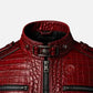 Close-up of a red crocodile-embossed leather jacket with a high collar, silver-tone hardware, and zippered details on a light gray background.