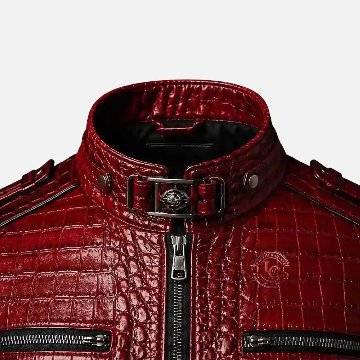 Close-up of a red crocodile-embossed leather jacket with a high collar, silver-tone hardware, and zippered details on a light gray background.
