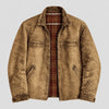 A men's distressed brown jacket with a rugged, washed texture, featuring a zippered front, chest flap pockets, and a visible red and brown plaid lining, shown against a light gray background.