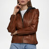 Brown leather jacket worn by a person on a white background