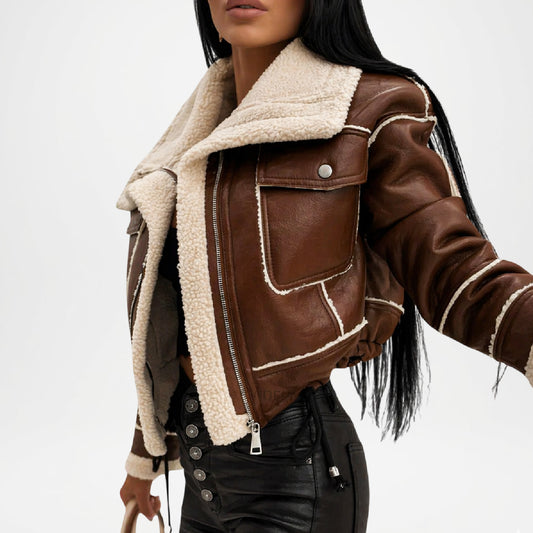 Brown leather jacket with white fur lining worn by a person on a white background