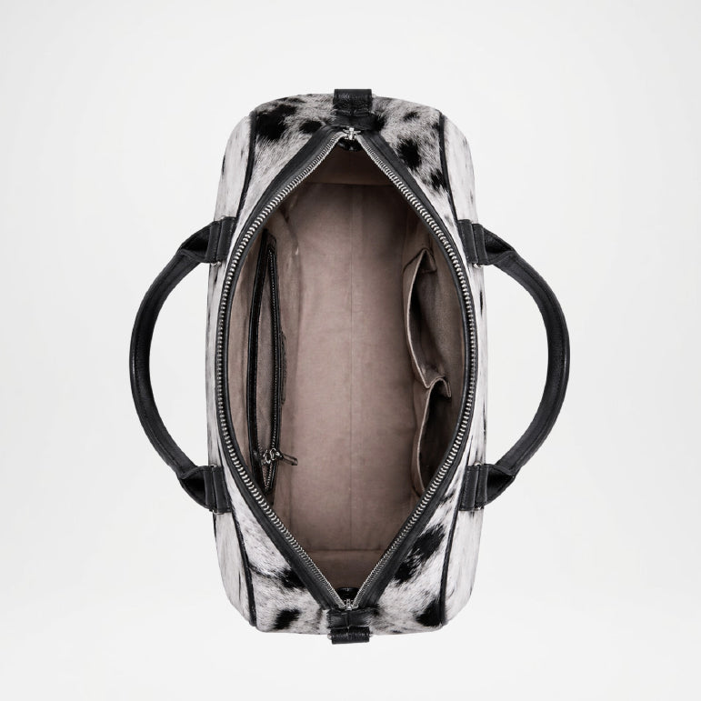 Black and white patterned duffel bag with open zipper 