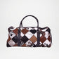 Patchwork patterned duffel bag with brown, black, and white colors