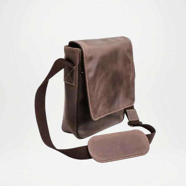Brown leather crossbody bag on a light gray background