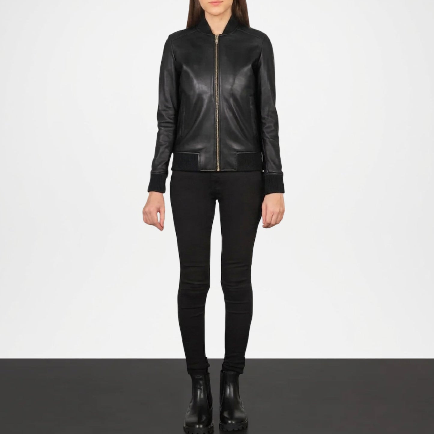 Person wearing a black leather jacket and pants on a white background