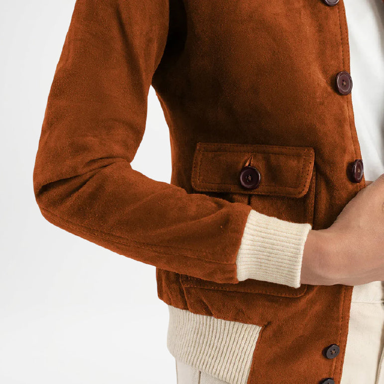 Brown corduroy jacket with white cuffs and buttons