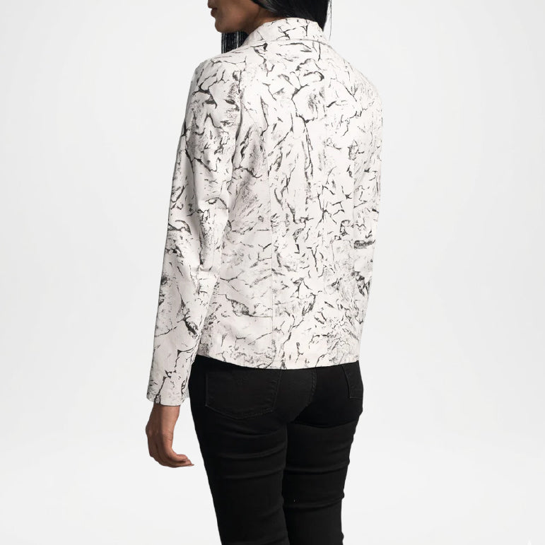 Person wearing a white jacket black view with black abstract pattern 