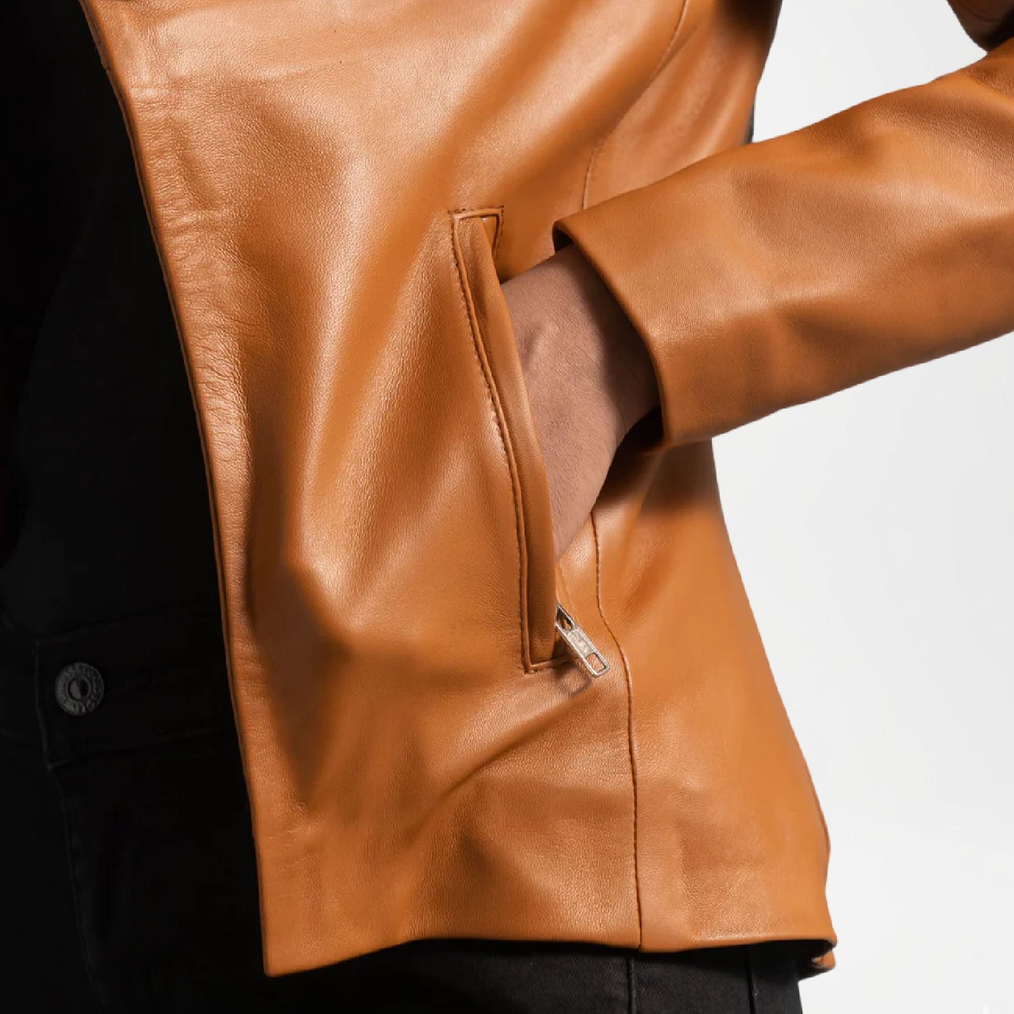 Close-up of a brown leather jacket with a blurred background