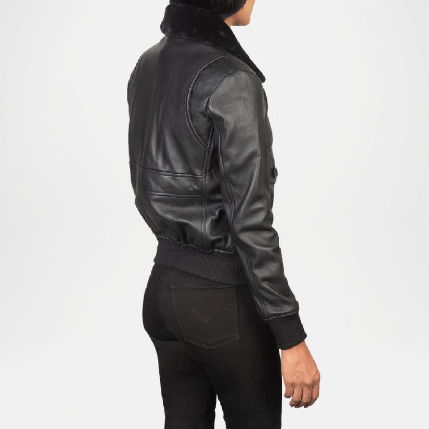 Person wearing a black leather jacket with fur collar