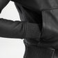 Close-up of a black leather jacket with textured cuffs and waistband