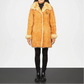 wearing a long brown fur coat with a white background