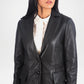 Black leather jacket worn by a person on a white background