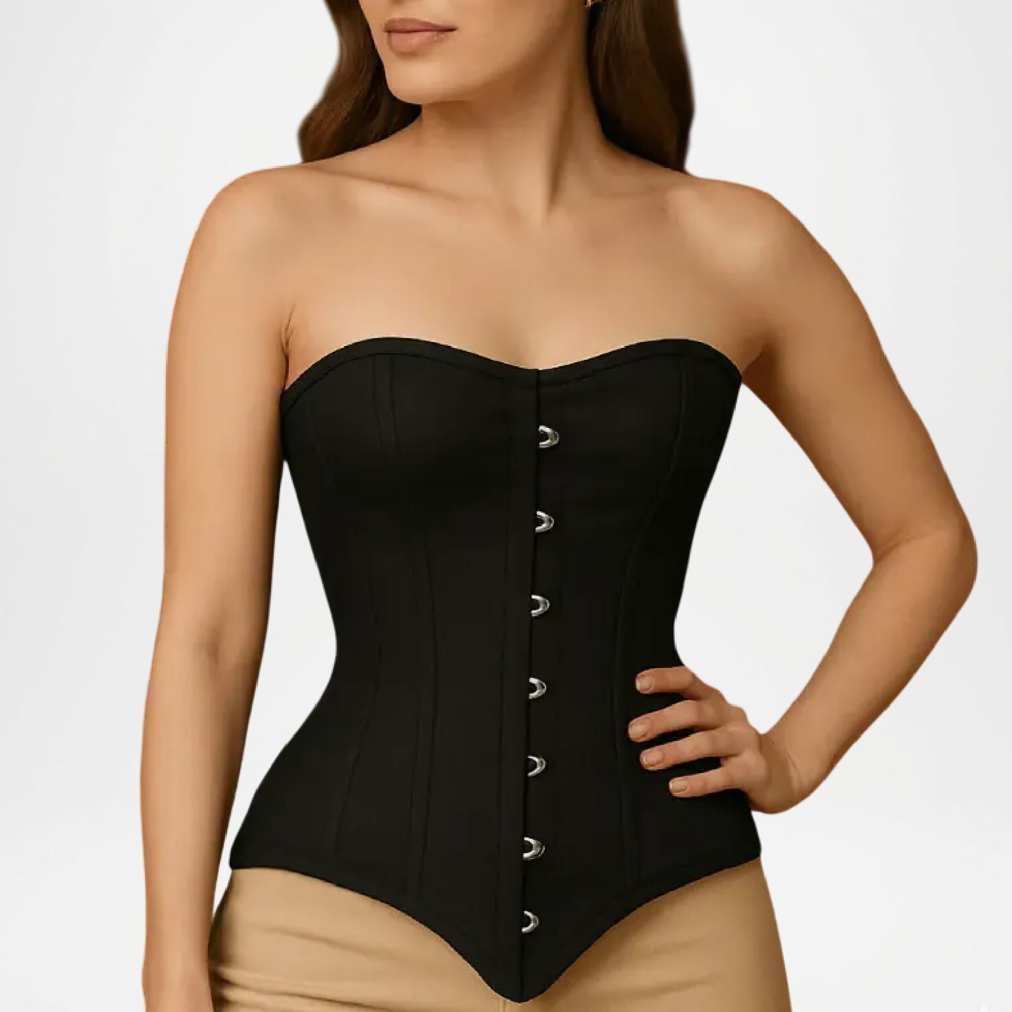 Black strapless corset worn by a model on a plain background