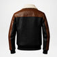 A luxury leather jacket shown from the back, featuring a black crocodile-embossed body, brown alligator-patterned shoulder and sleeve panels, and a cream-colored shearling collar, set against a plain light gray background.
