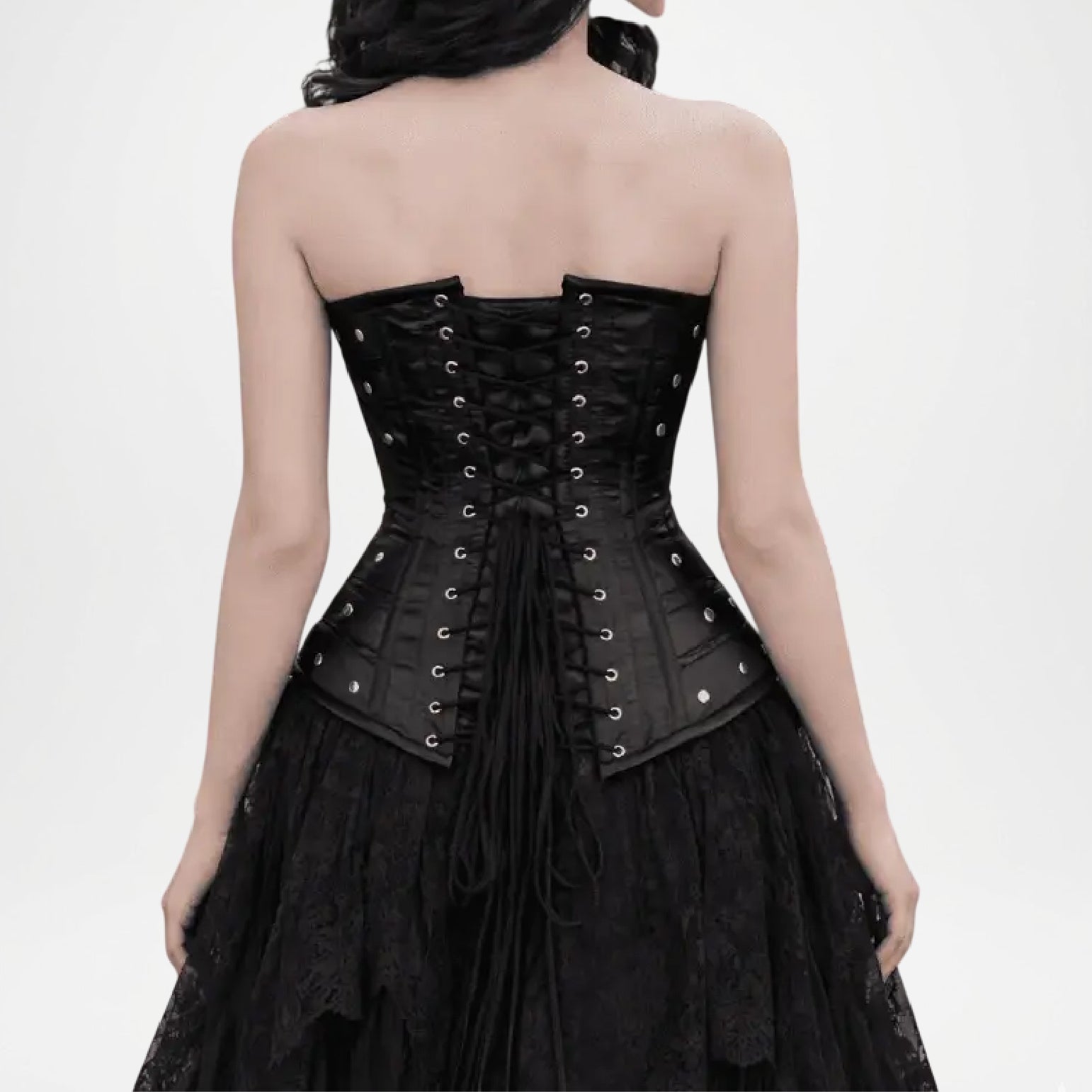 Black corset worn by a model on a white background