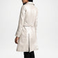 Person wearing a light-colored coat women back view