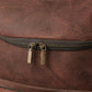 Close-up of a brown leather bag with a zipper