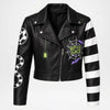 Black faux leather moto jacket with a 'Beetlejuice' spiderweb graphic on the chest, a green spider hanging from the zipper pull, a black-and-white striped right sleeve, a white-and-black snake print on the left sleeve, and a white skull graphic on the right shoulder.