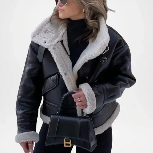 Woman wearing a black leather jacket with white fur lining, holding a black handbag.