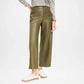 Person wearing olive green leather pants on a white background