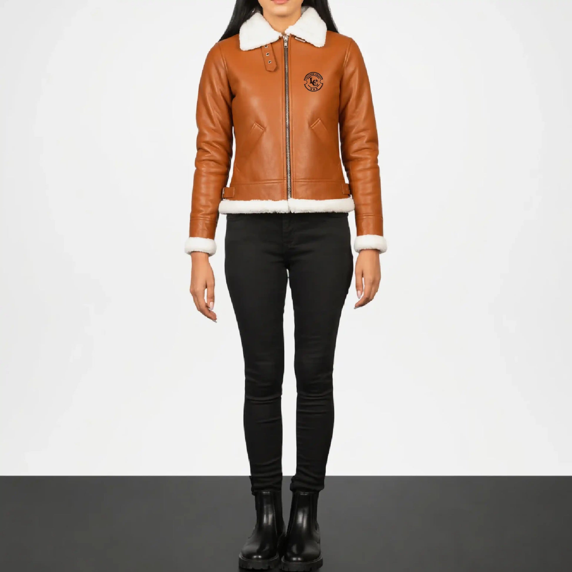 Person wearing a brown leather jacket with white fur lining 