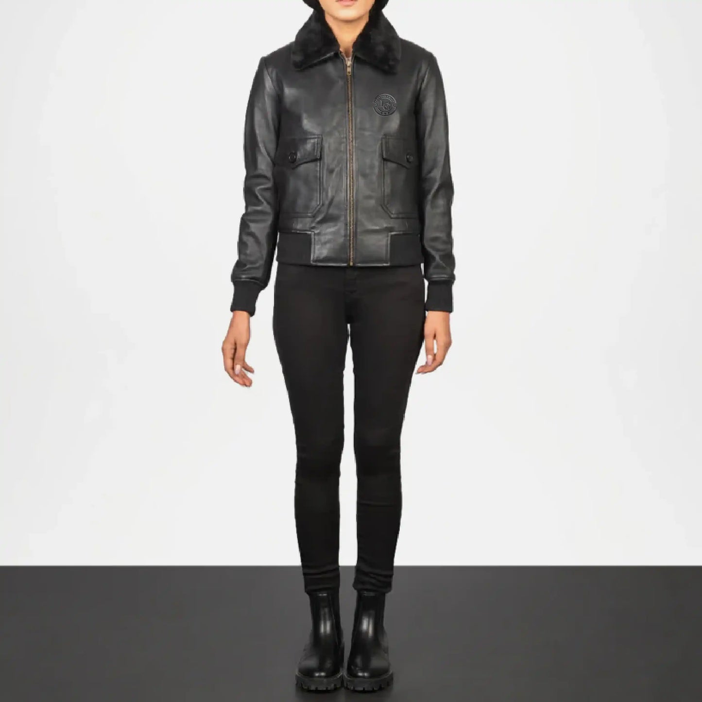 Person wearing a black leather jacket with fur collar 