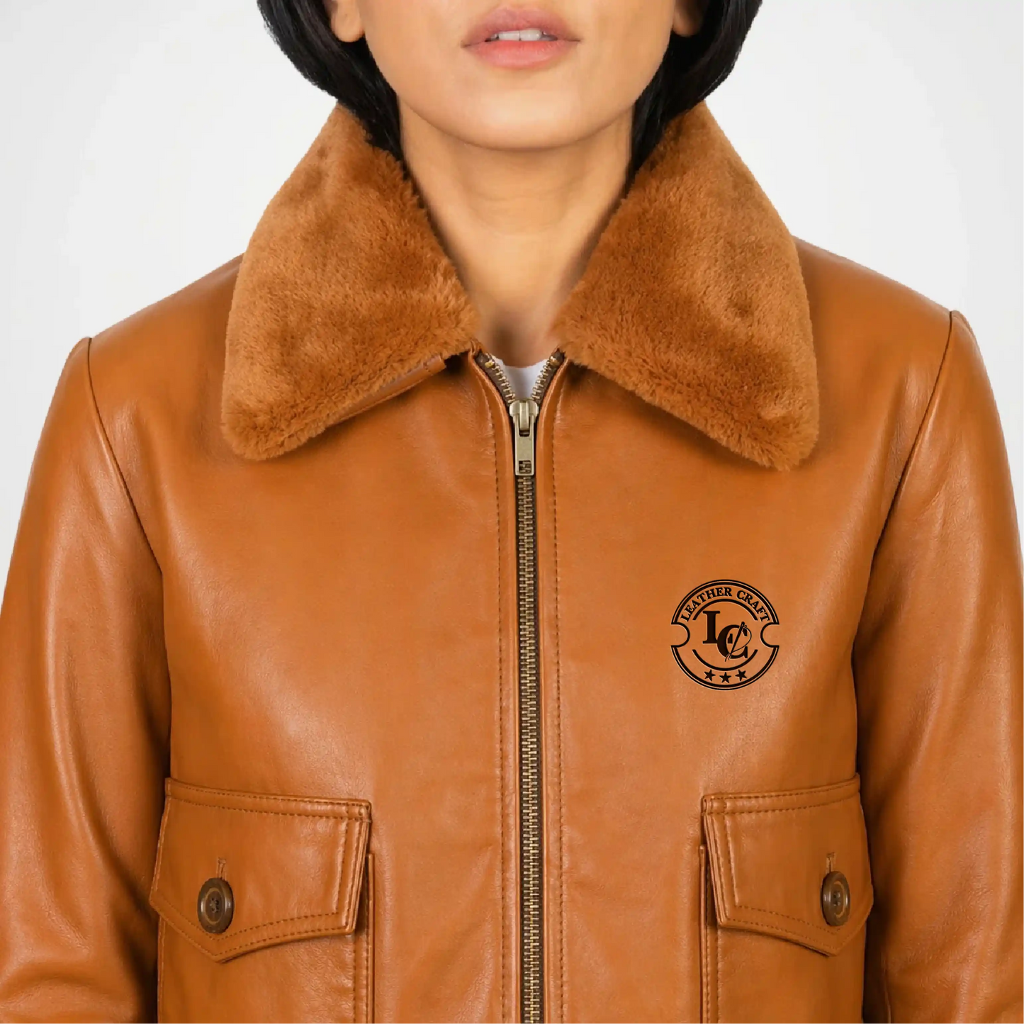 Brown leather jacket with fur collar and logo on a white background close up