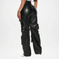 Black leather cargo pants worn by a person on a white background