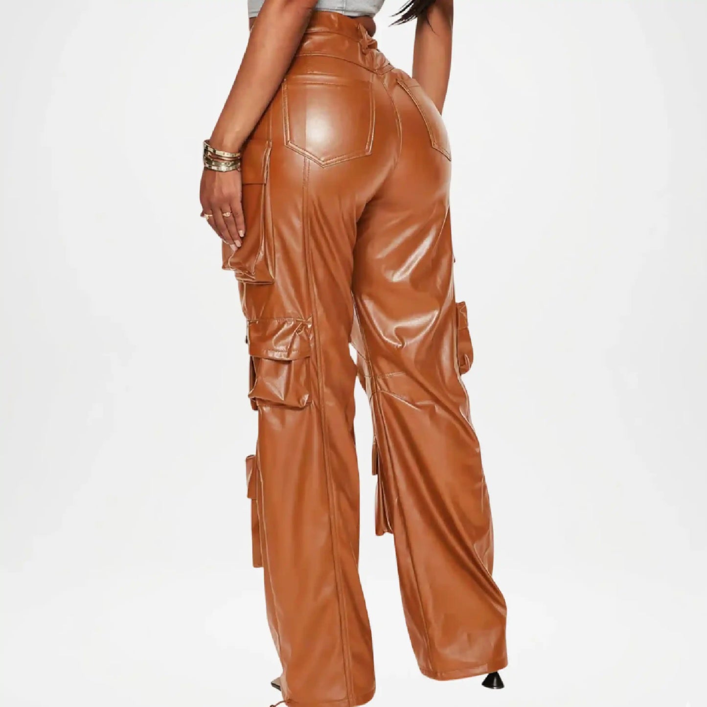 Brown leather pants worn by a person on a white background