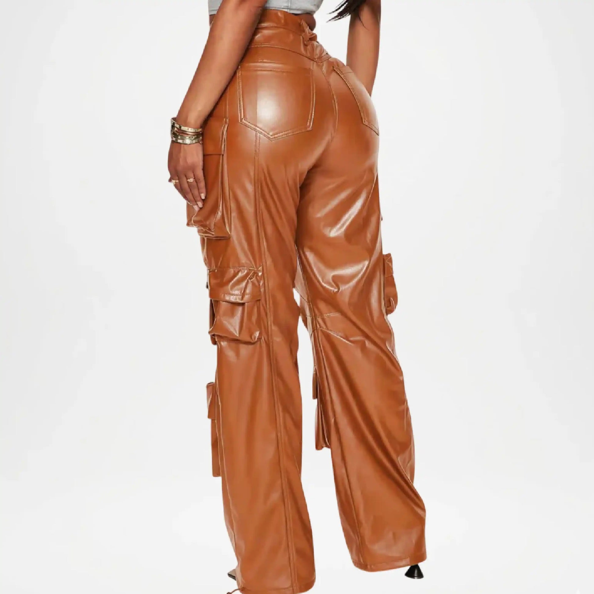 Brown leather pants worn by a person on a white background