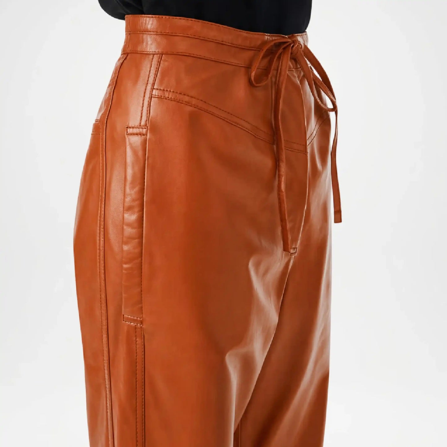 brown leather jogger pants women close up
