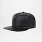 Black leather cap on a light gray background