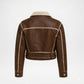 A brown leather jacket with a beige shearling-style collar and contrasting beige stitching, shown from the back on a light gray background.