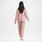 Person wearing a pink tracksuit on back view