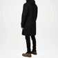 Person wearing a black coat on a white background