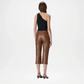 Woman wearing brown leather pants back side on a white background