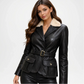 Woman wearing a black leather jacket with a white fur collar on a white background
