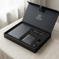 Black leather craft set with wallet, cardholder, and pen in a box on a light surface.