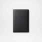 Black leather notebook on a light gray background