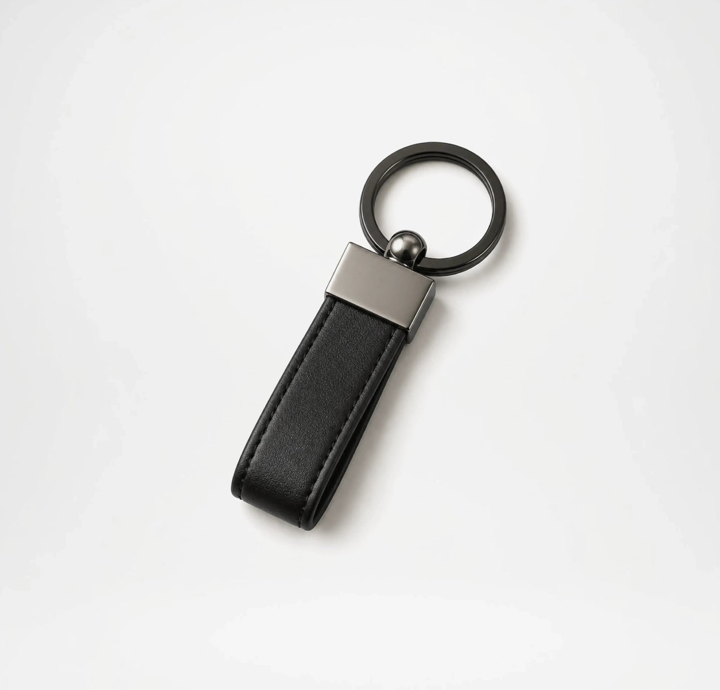 Black leather keychain with metallic accent