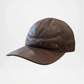 Brown leather cap on a light gray background