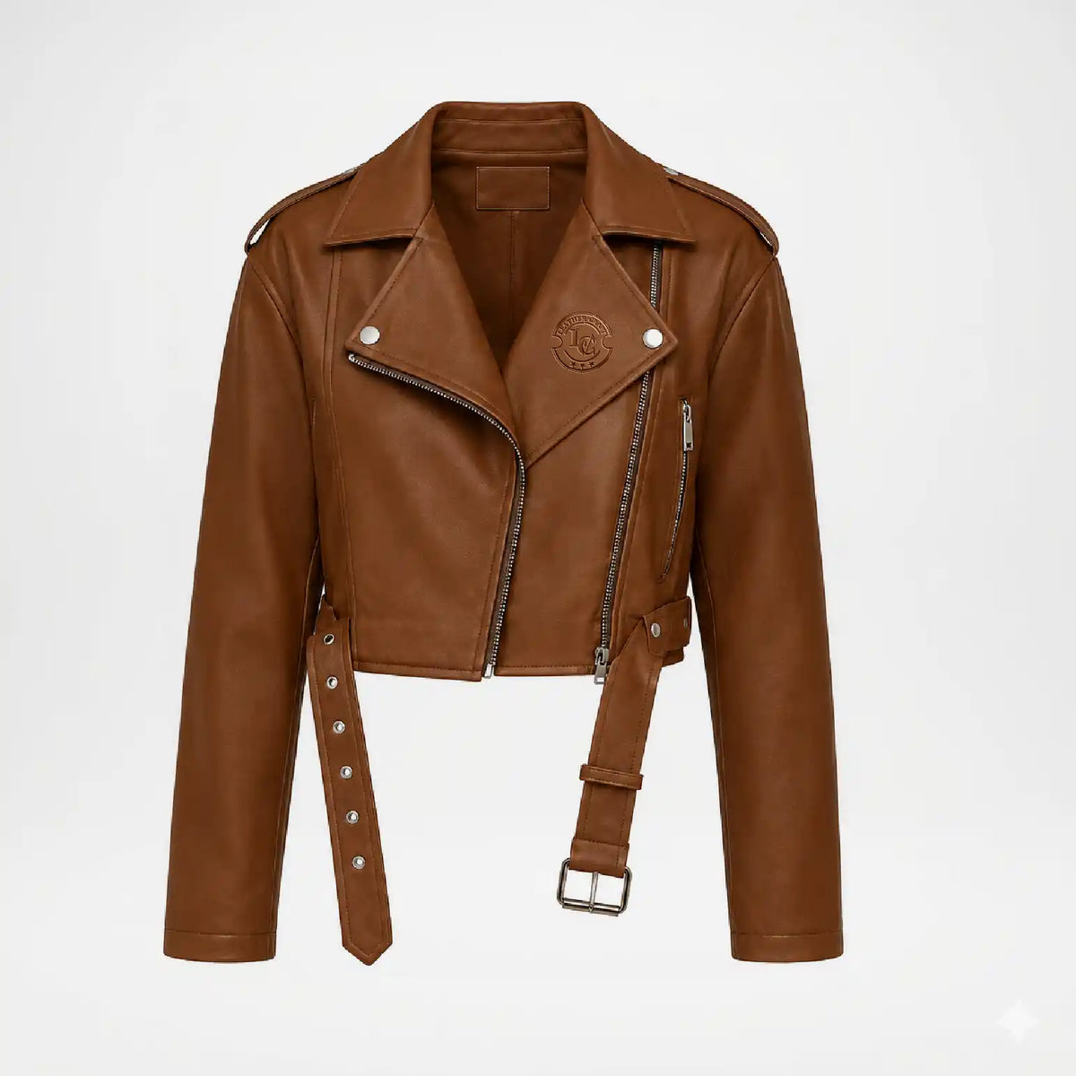 A cropped brown faux-leather moto jacket with a belted waist, silver-tone hardware, and a circular embroidered logo on the chest, displayed on a clean white background.