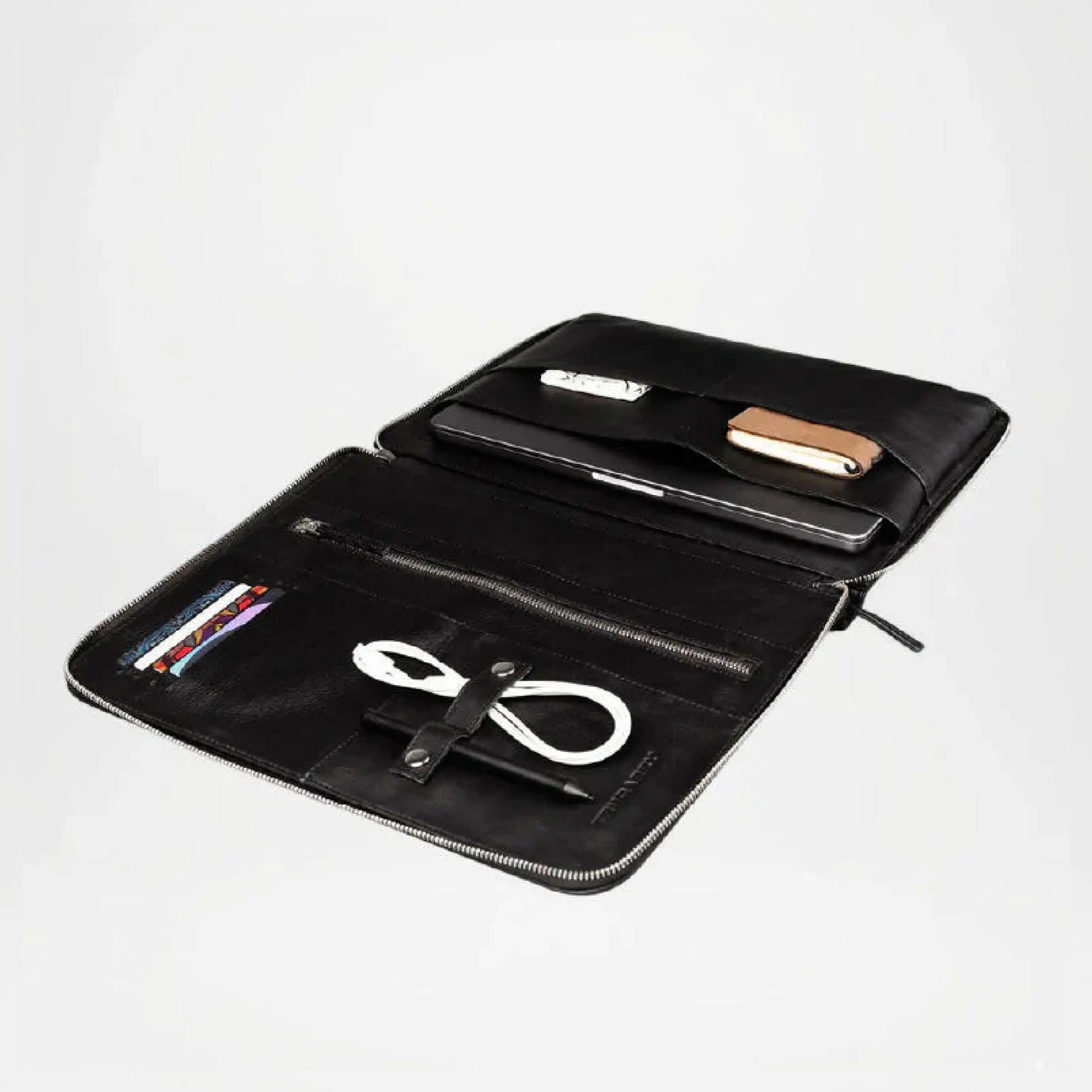 Black leather pouch with compartments holding electronic devices on a white background