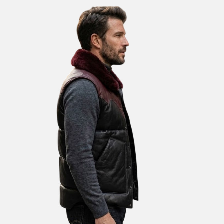 Man wearing a black vest with a fur-lined hood on a white background