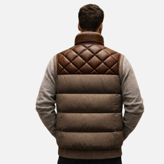 Man wearing a brown quilted vest over a gray sweater on a white background